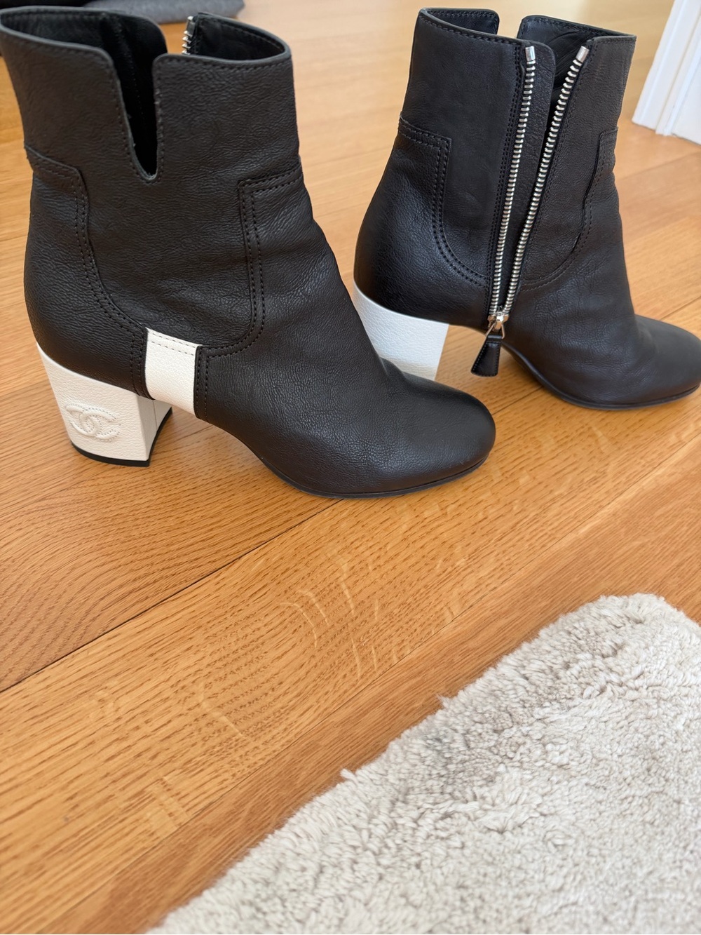 CHANEL Black Leather Ankle Boots with White Block Heel Accent